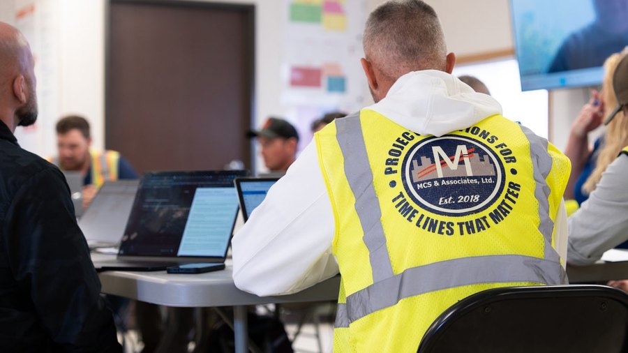 MCS representative at the project table wearing an MCS vest